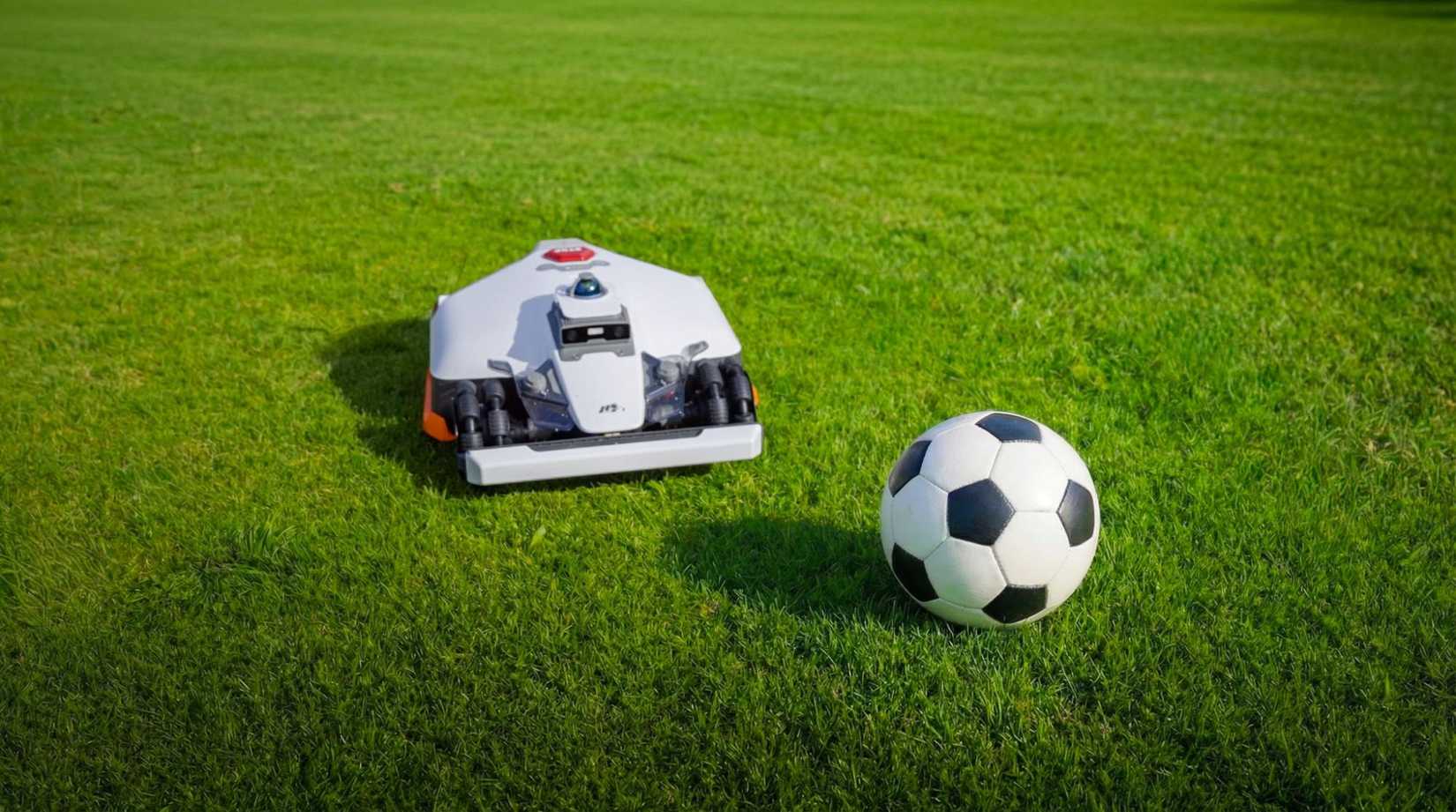 Mammotion LUBA 3 robot mower next to a soccer ball on a lawn.