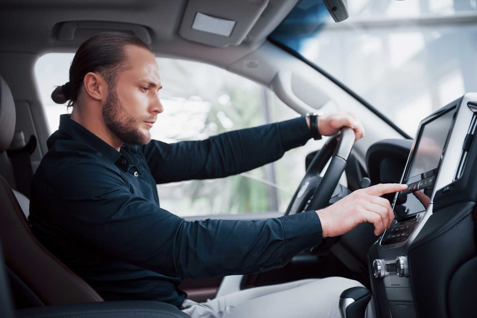 Man adjusting touchscreen settings in a car