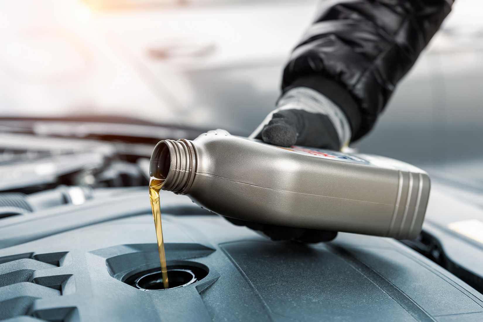 Mechanic adding engine oil