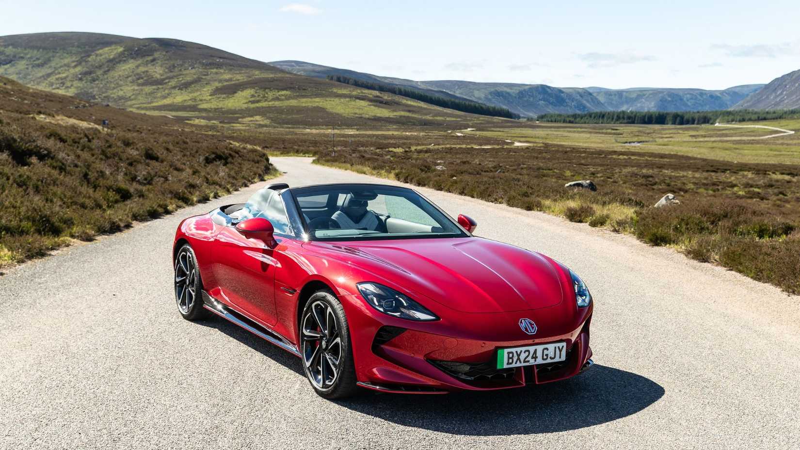 Static front 3/4 shot of a red MG Cyberster.