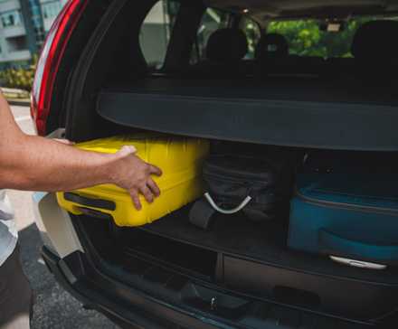 Packing luggage into an SUV for travel