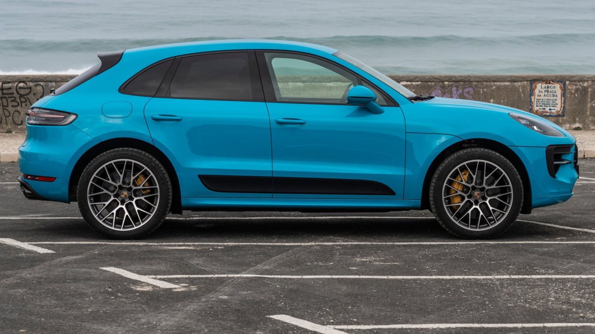 Static side profile shot of a blue 2020 Porsche Macan GTS.