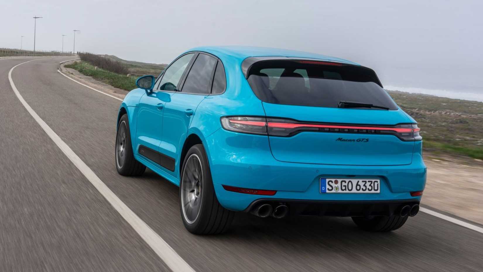 Dynamic rear 3/4 shot of a blue 2020 Porsche Macan GTS.
