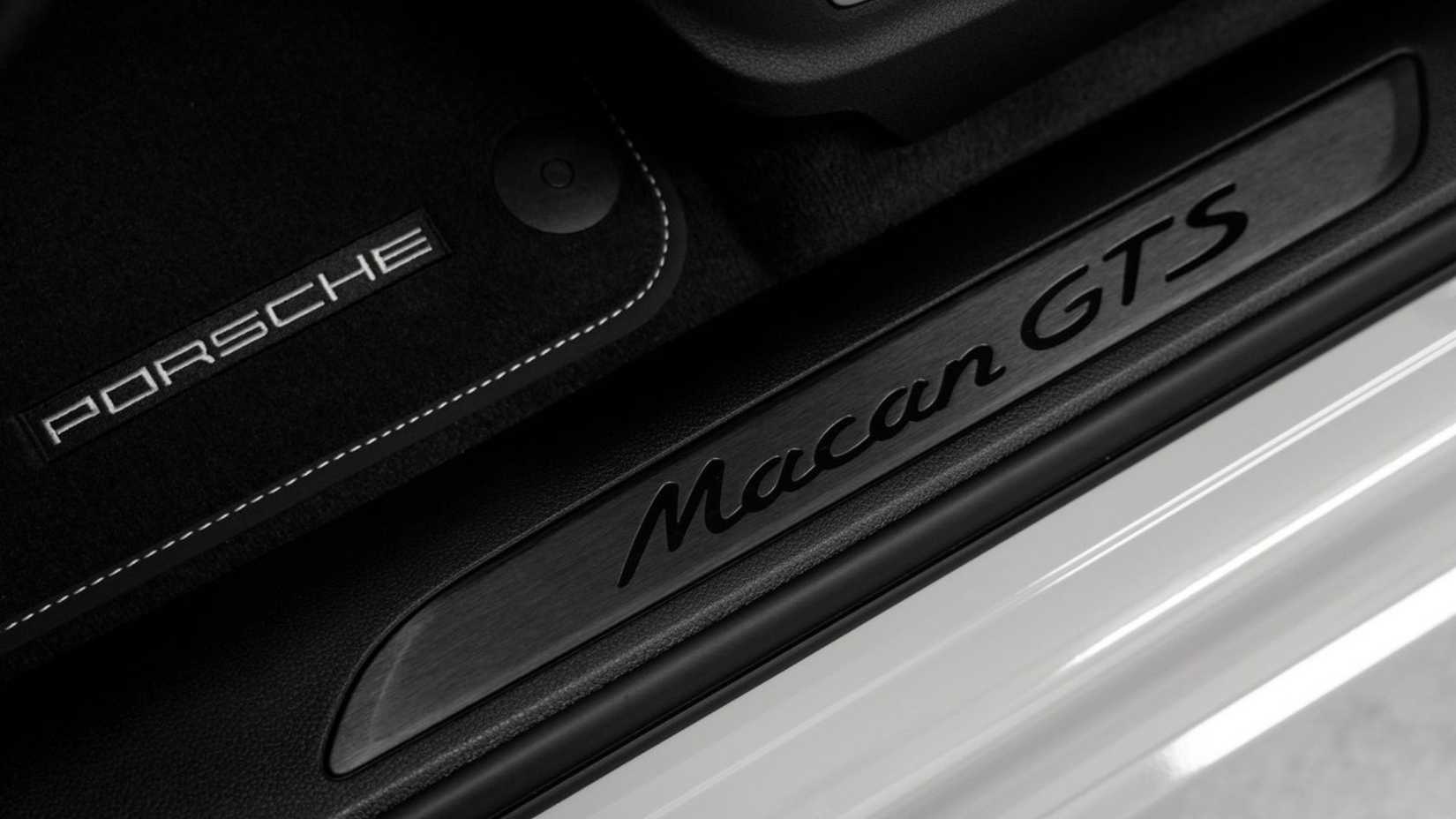 Close-up shot of the tread plate on a white 2020 Porsche Macan GTS.