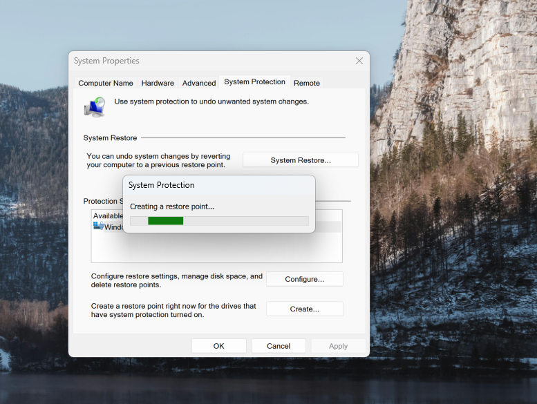 A screenshot of Windows 11 search open to the Windows Recovery settings with the Create a restore point dialog running.