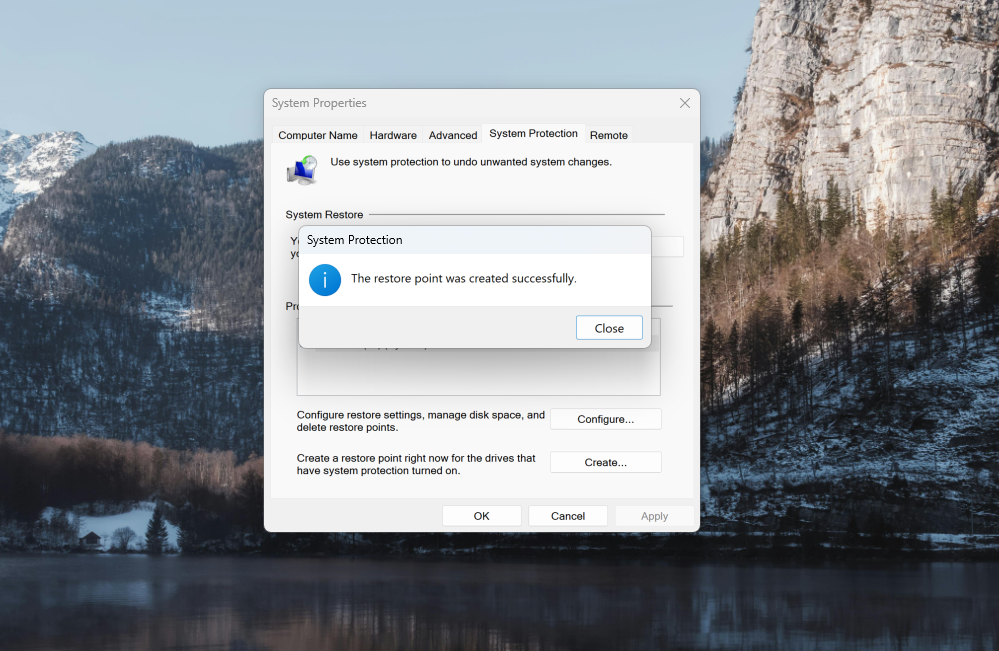 A screenshot of Windows 11 search open to the Windows Recovery settings with the Create a System Restore point dialog box indicating you have successfully created a restore point.