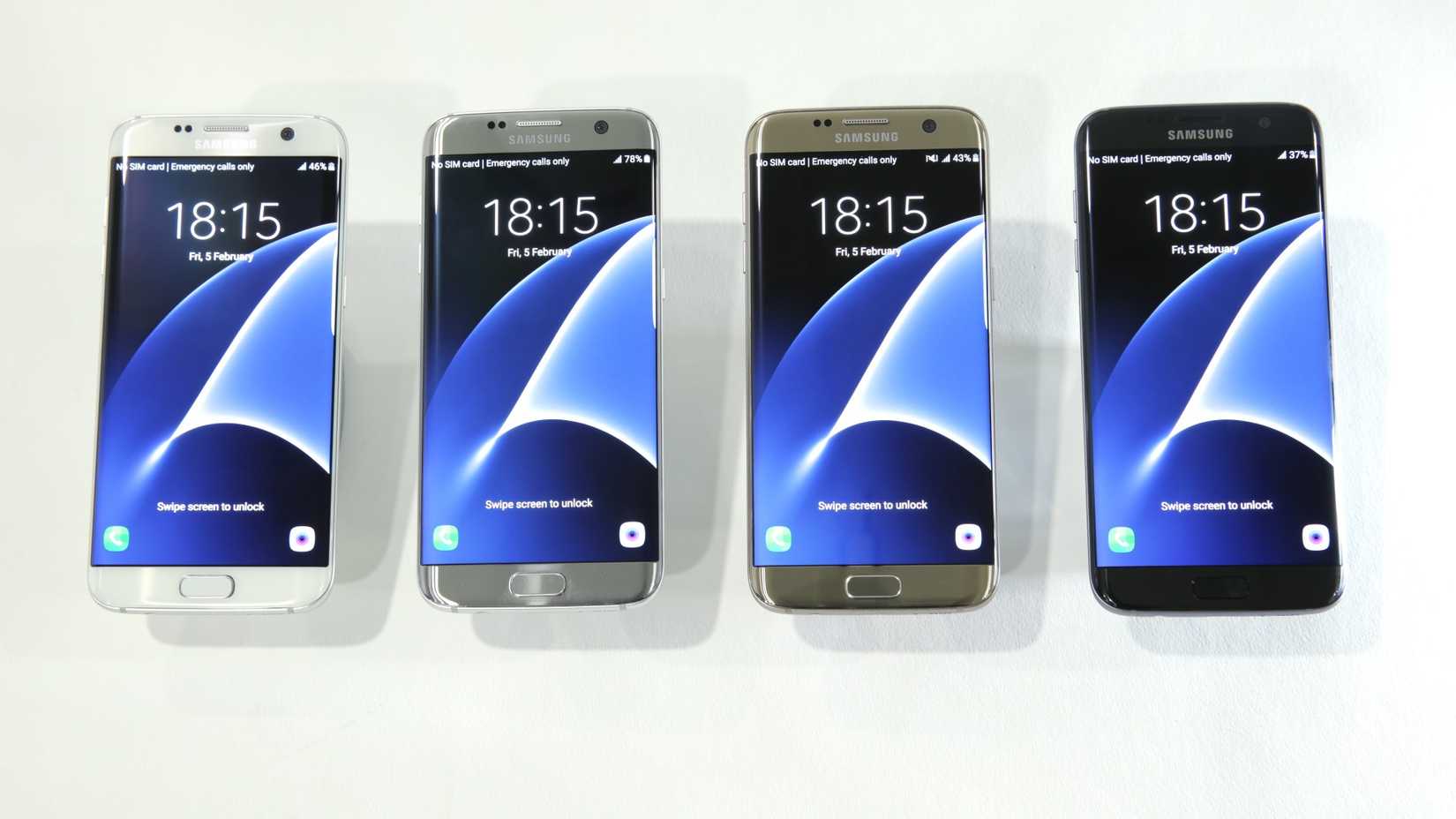 Four Samsung Galaxy S7 Edge phones in different colors lying on a table. 