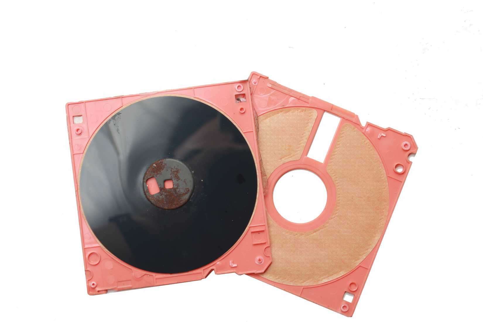 An old computer floppy disk, taken apart to see the inside.