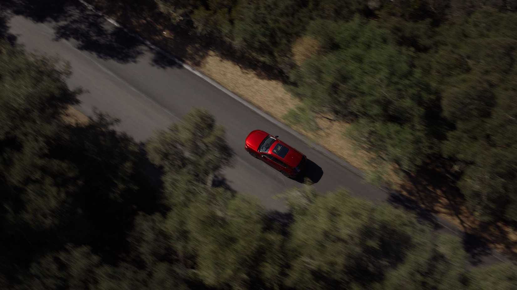 Dynamic overhead rear 3/4 shot of a red 2026 Mazda CX-5.