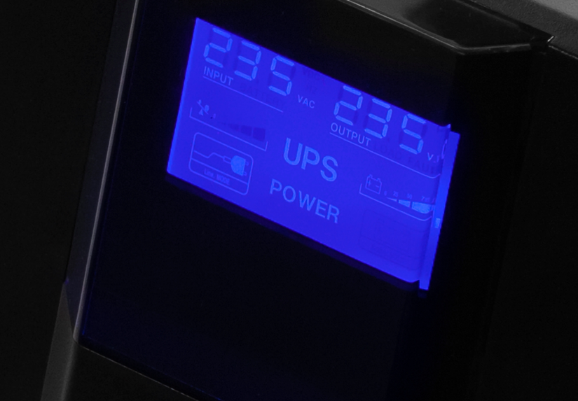 A close up of an LED display on a UPS unit showing power out and in on the unit.