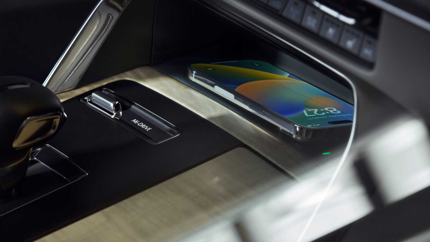 Close-up shot of the wireless charger in the center console of a 2024 Mazda CX-90.