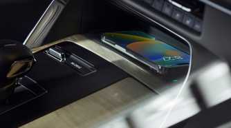 Close-up shot of the wireless charger in the center console of a 2024 Mazda CX-90.