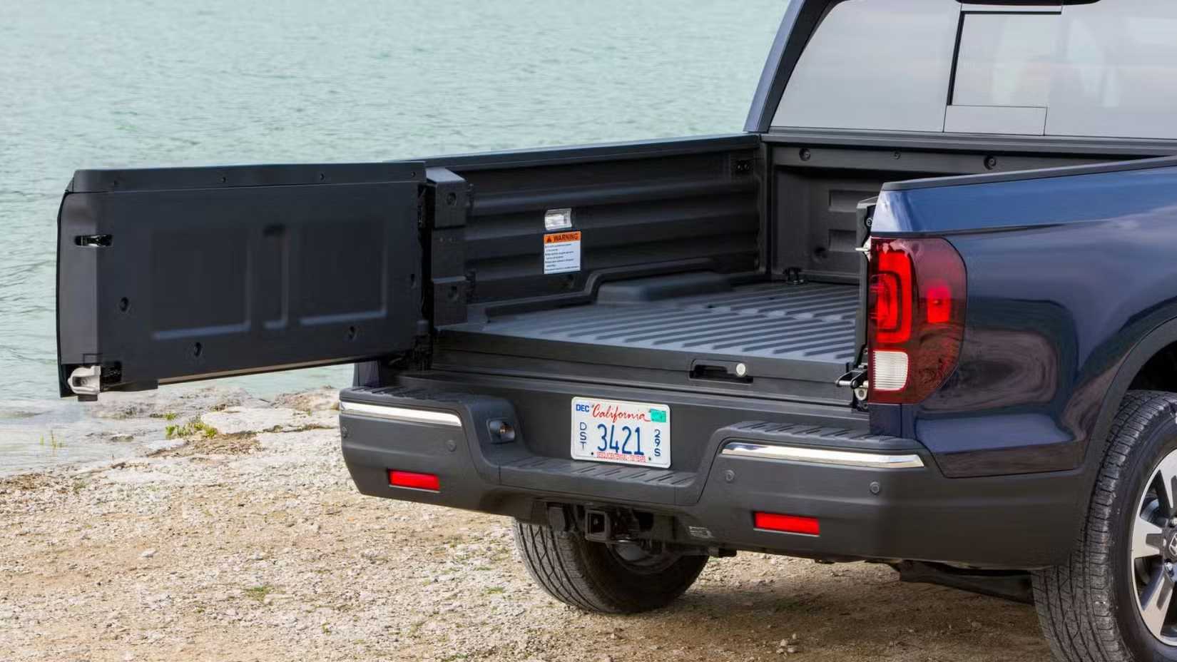 Close-up shot of the dual-action tailgate on a blue 2025 Honda Ridgeline.