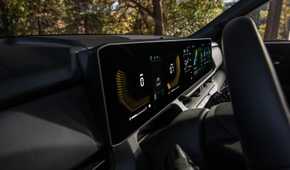 Close up shot of the digital gauge cluster and infotainment screen in a 2027 Kia Seltos