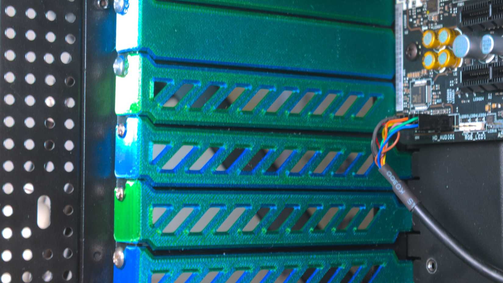 3D printed PCIe slot covers installed in the back of a case.