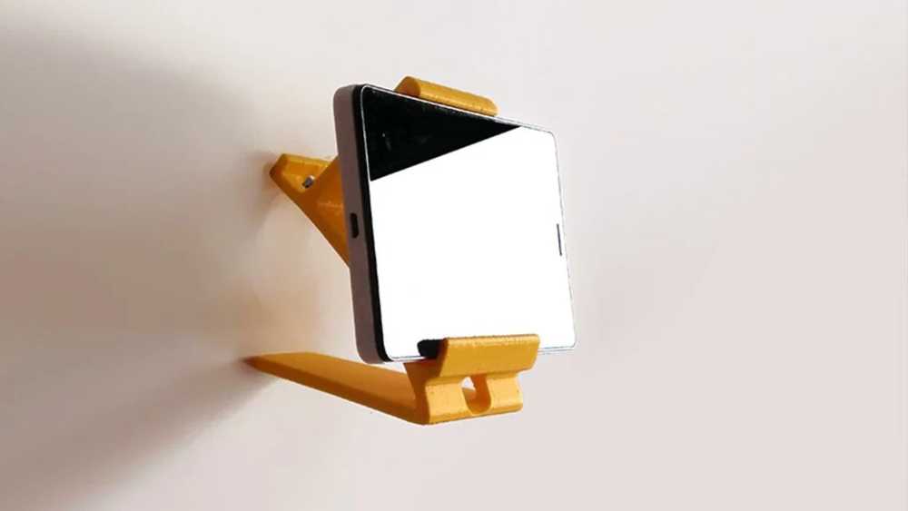 A wall-mounted phone stand printed to fit a specific device and location