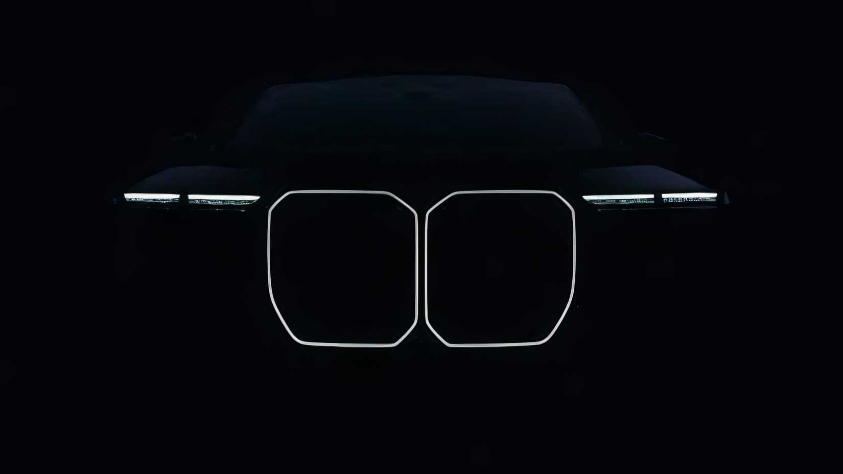 BMW i7 EV teaser image with headlights.