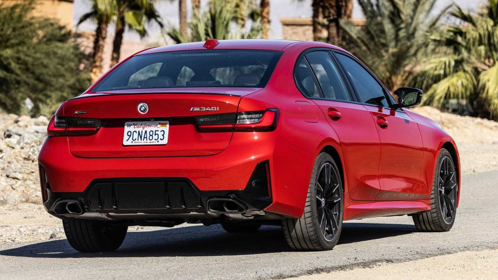 Static rear 3/4 shot of a red 2023 BMW M340i.