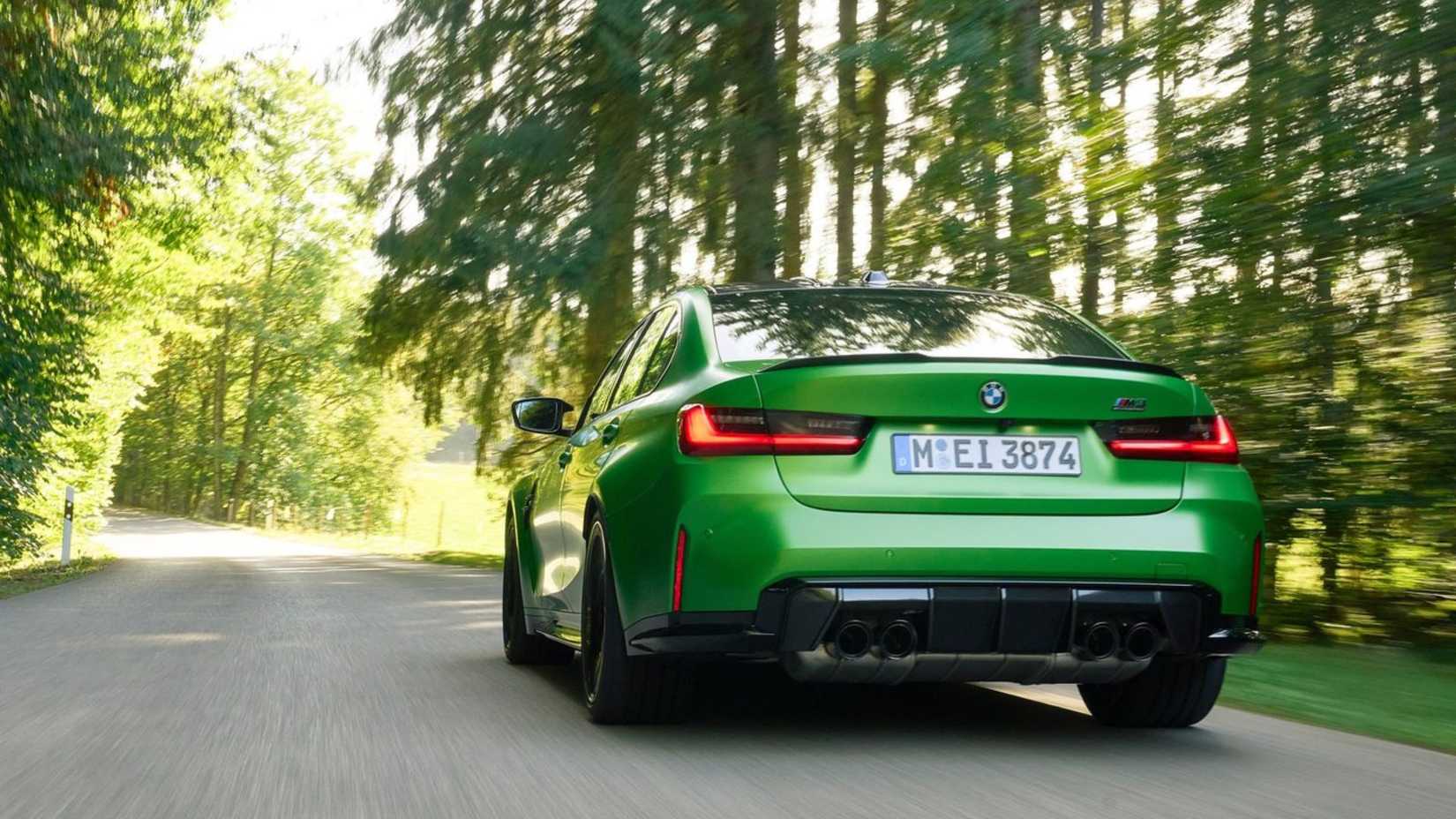Dynamic rear 3/4 shot of a green 2025 BMW M3 Sedan.