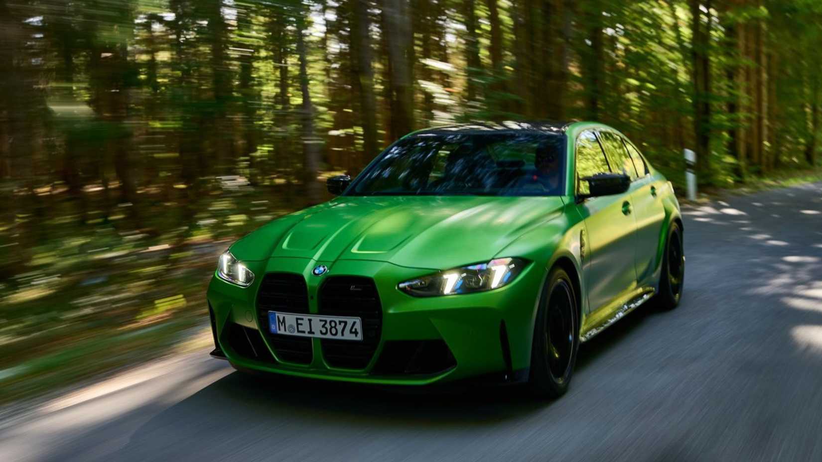 Dynamic front 3/4 shot of a green 2025 BMW M3 Sedan.