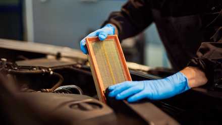 Car Mechanic Changing the Air Filter