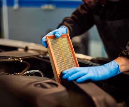 Car Mechanic Changing the Air Filter