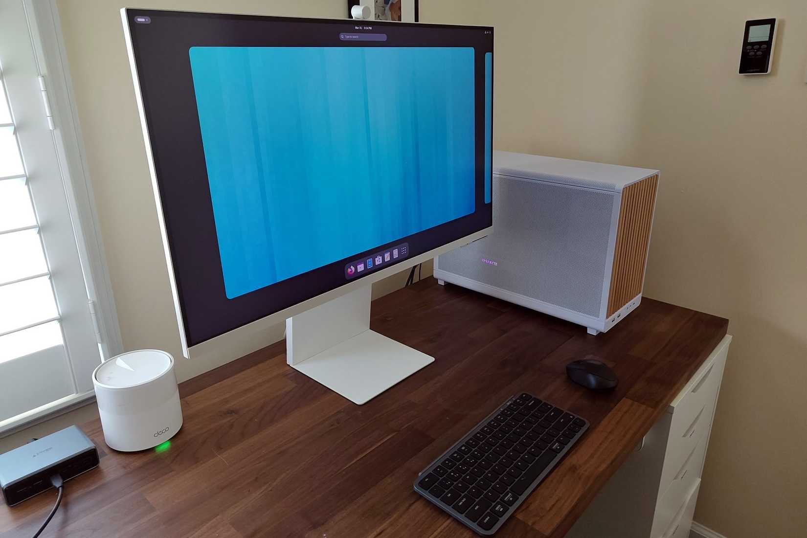 Fedora Silverblue on a Samsung Smart Monitor M8 with desktop tower, keyboard, and mouse.