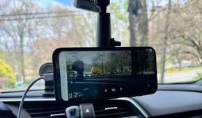 Phone magnetically mounted from the rear-view mirror in the car.