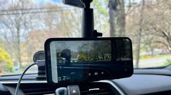 Phone magnetically mounted from the rear-view mirror in the car.