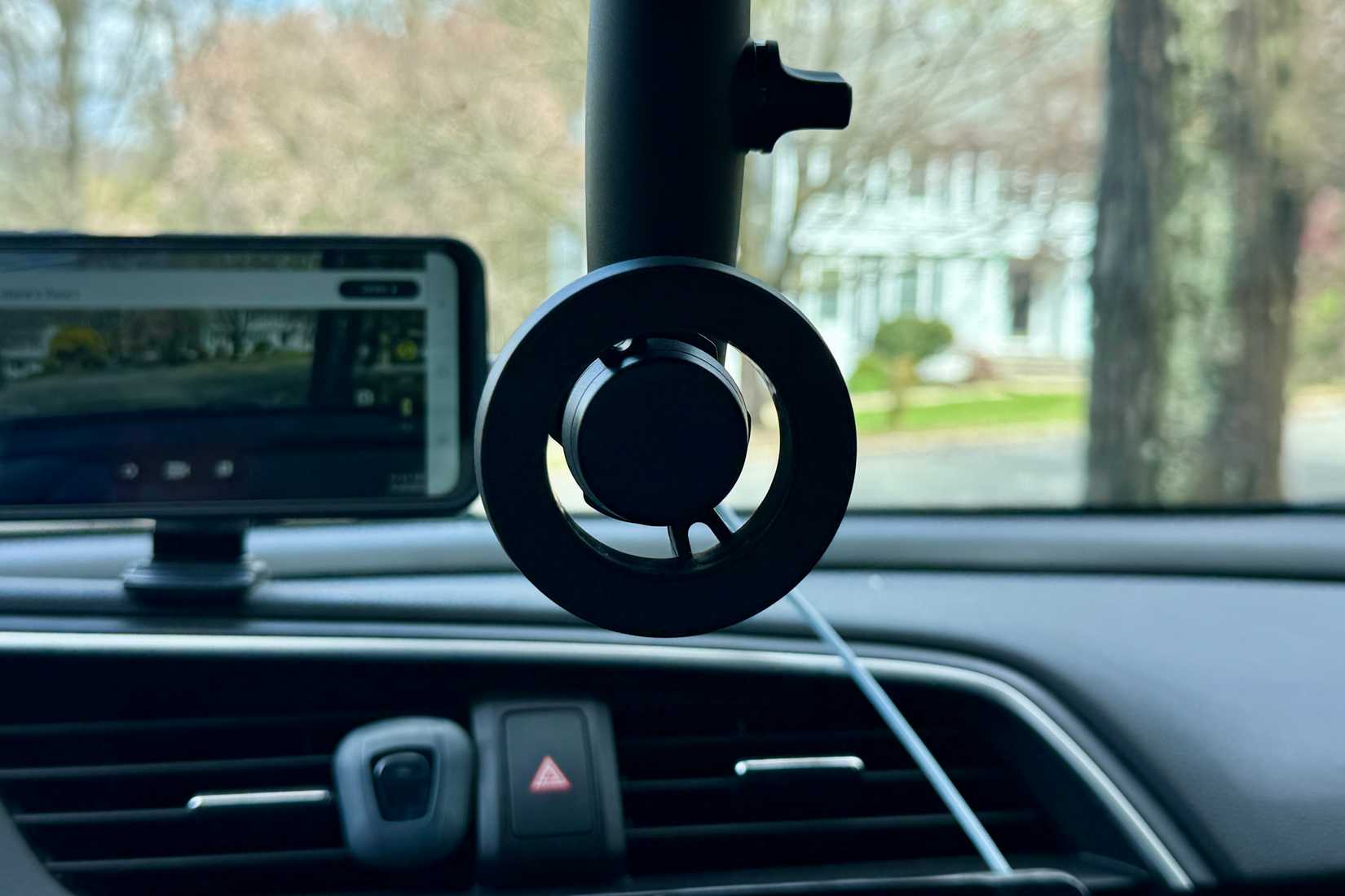 Magnetic phone holder from the rear-view mirror in a car.