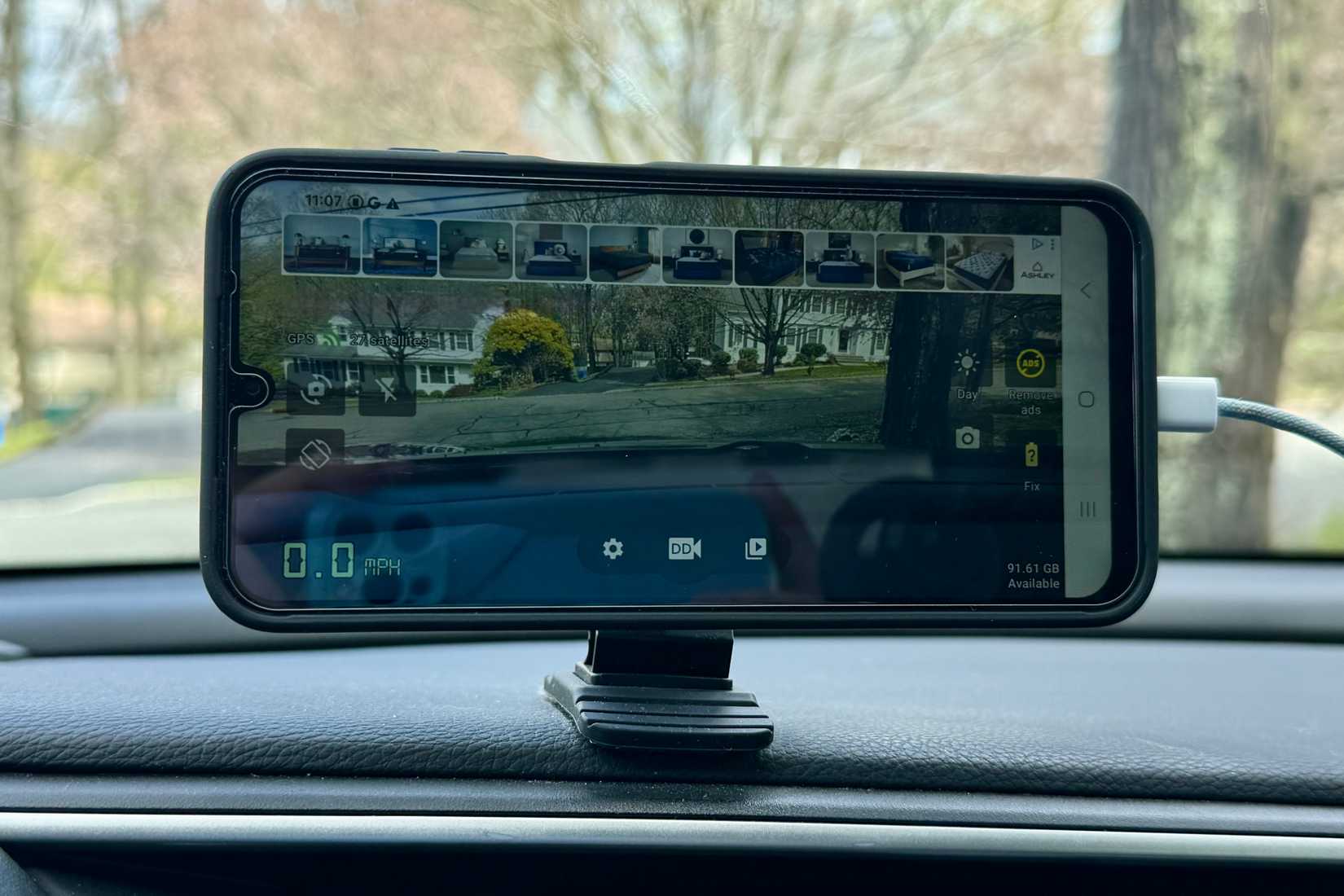 Ads in the dashcam app on a Samsung device in a car.