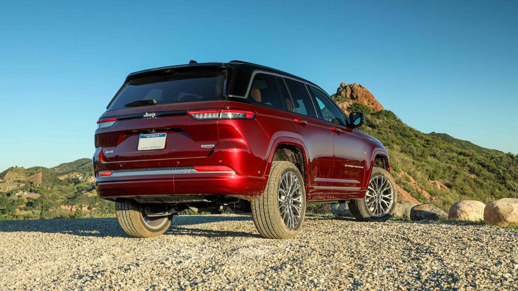 Static rear 3/4 shot of a red 2026 Jeep Grand Cherokee.