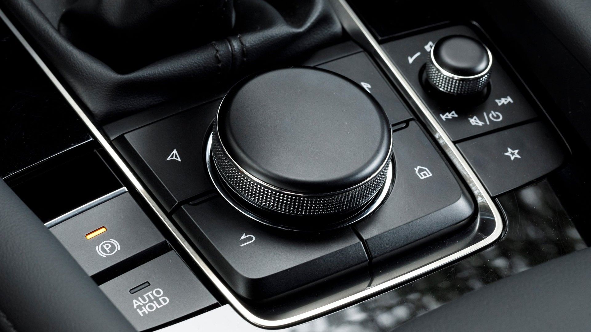 Shot of the rotary dial on the center console in a 2019 Mazda 3