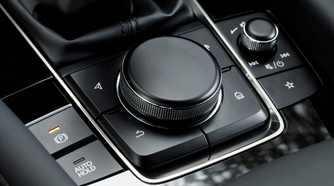 Shot of the rotary dial on the center console in a 2019 Mazda 3