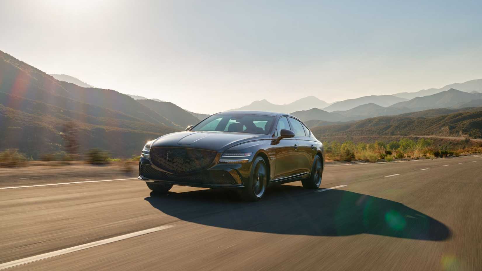 Dynamic front 3/4 shot of a black 2026 Genesis G80 Prestige Black.