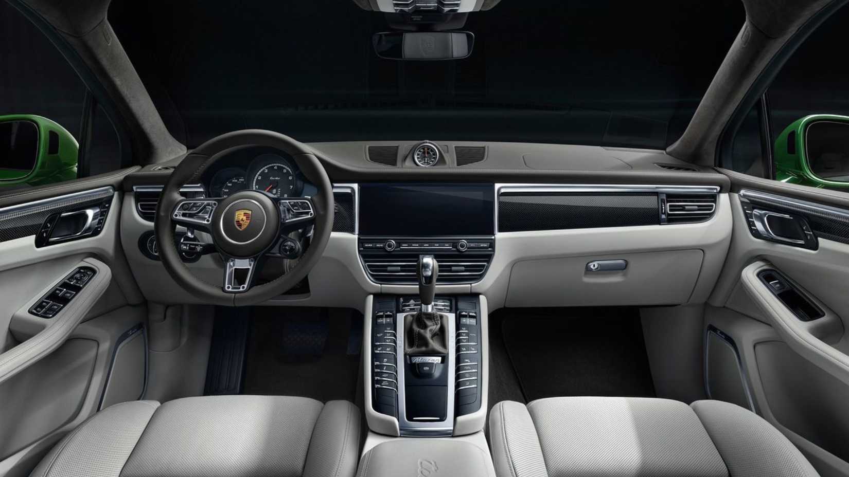 Shot inside the cabin of a 2019 Porsche Macan Turbo, showing the front seats and dashboard.