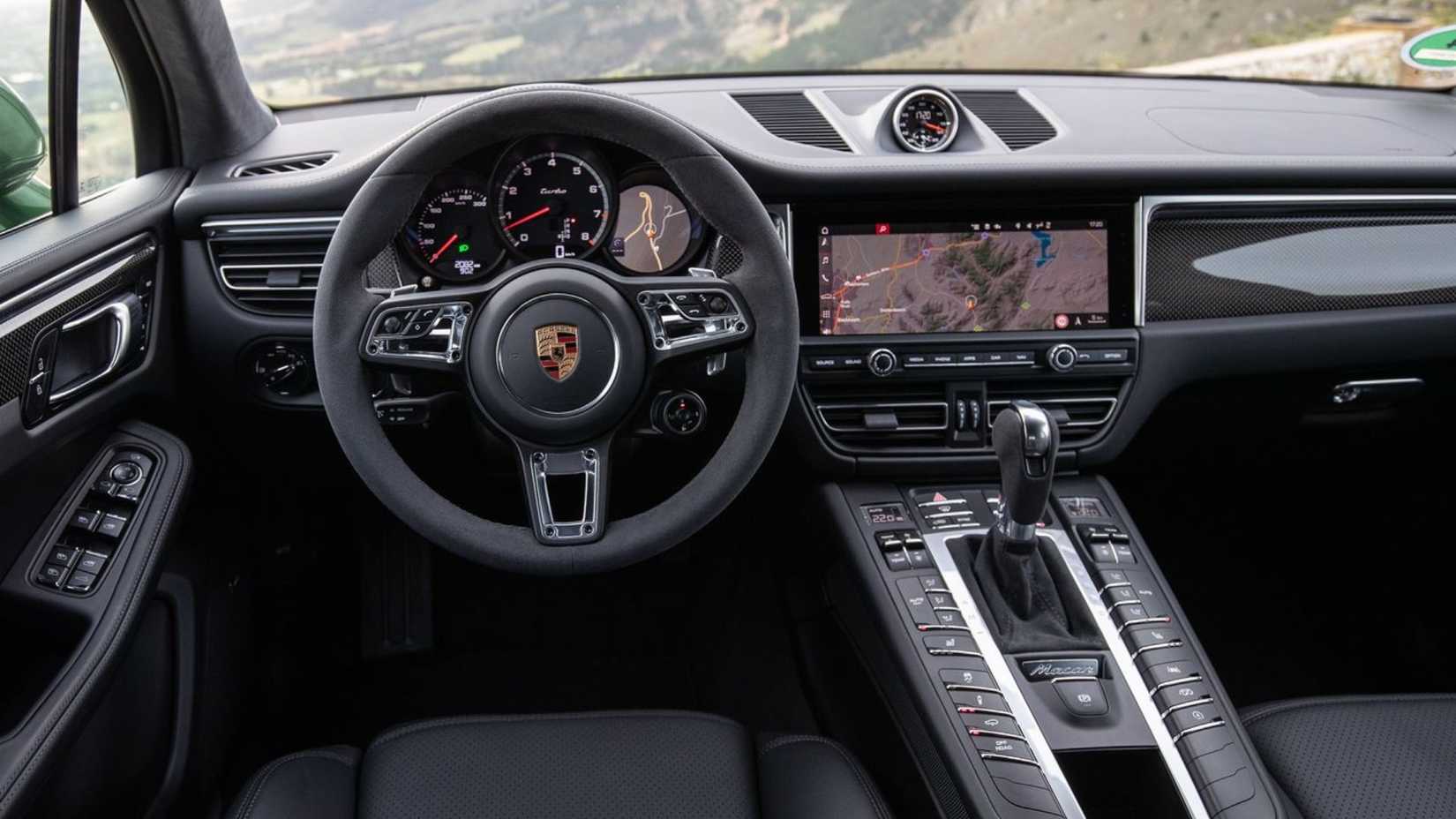 Close-up shot of the steering wheel and dashboard in a 2019 Porsche Macan Turbo.
