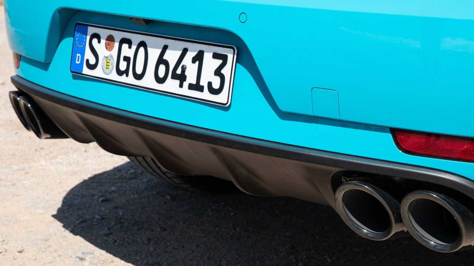 Close-up shot of the rear diffuser and quad tailpipes on a blue 2019 Porsche Macan Turbo.