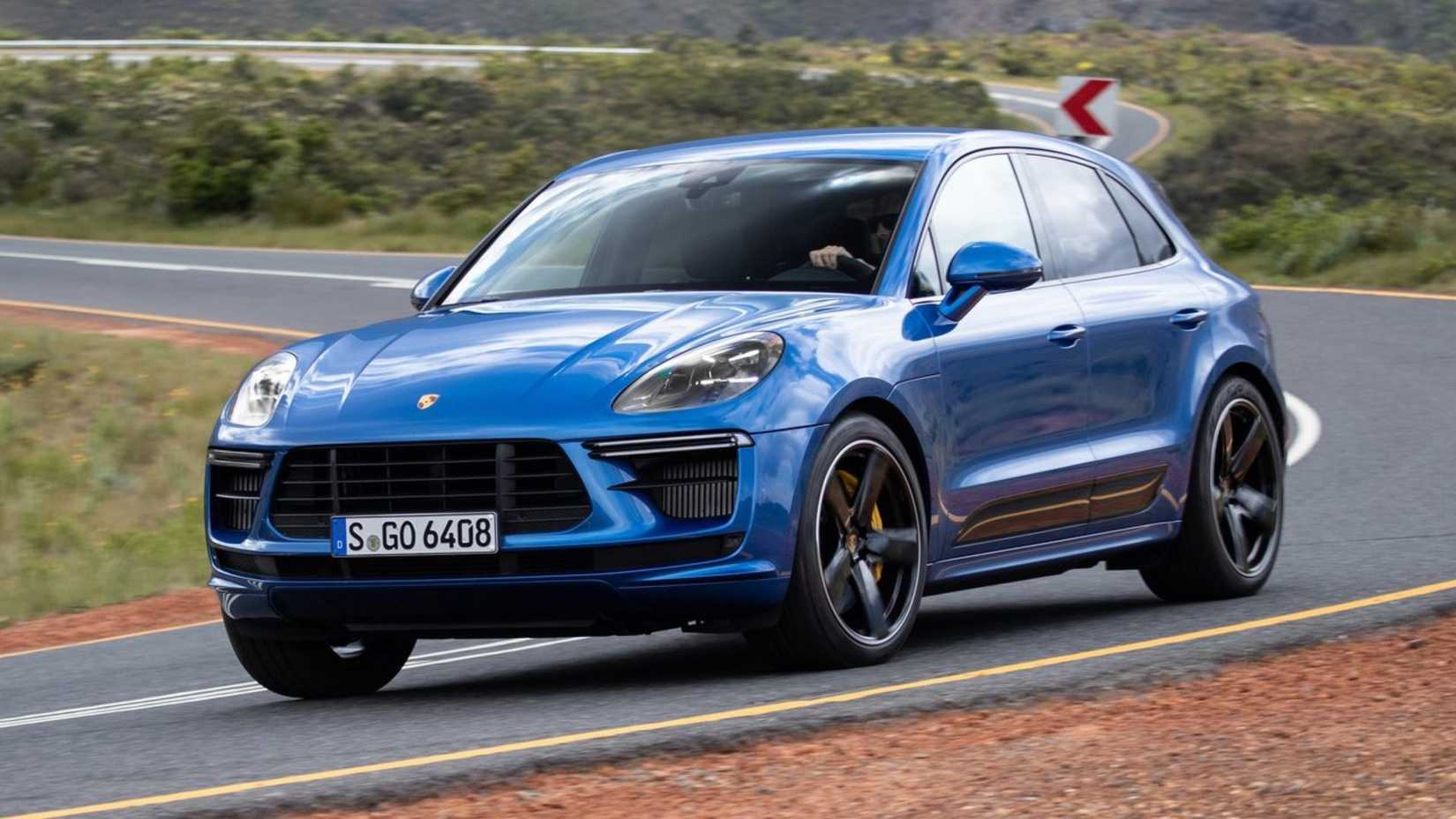 Dynamic front 3/4 shot of a blue 2019 Porsche Macan Turbo.