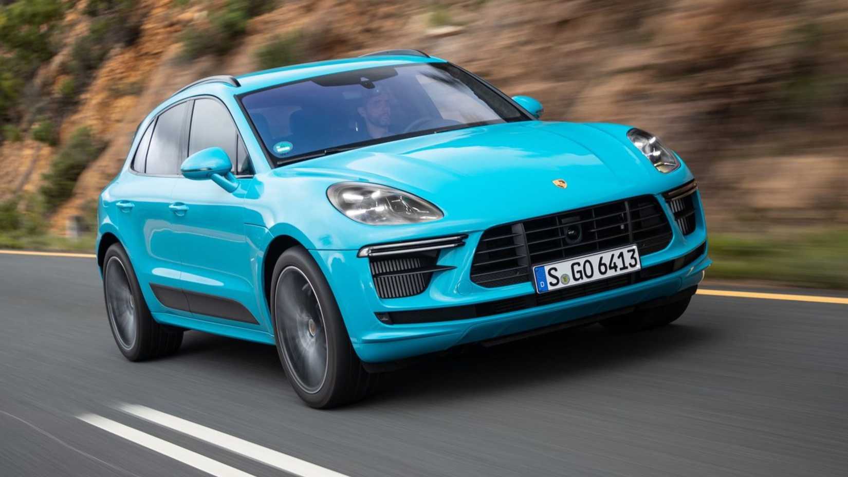 Dynamic front 3/4 shot of a blue 2019 Porsche Macan Turbo.