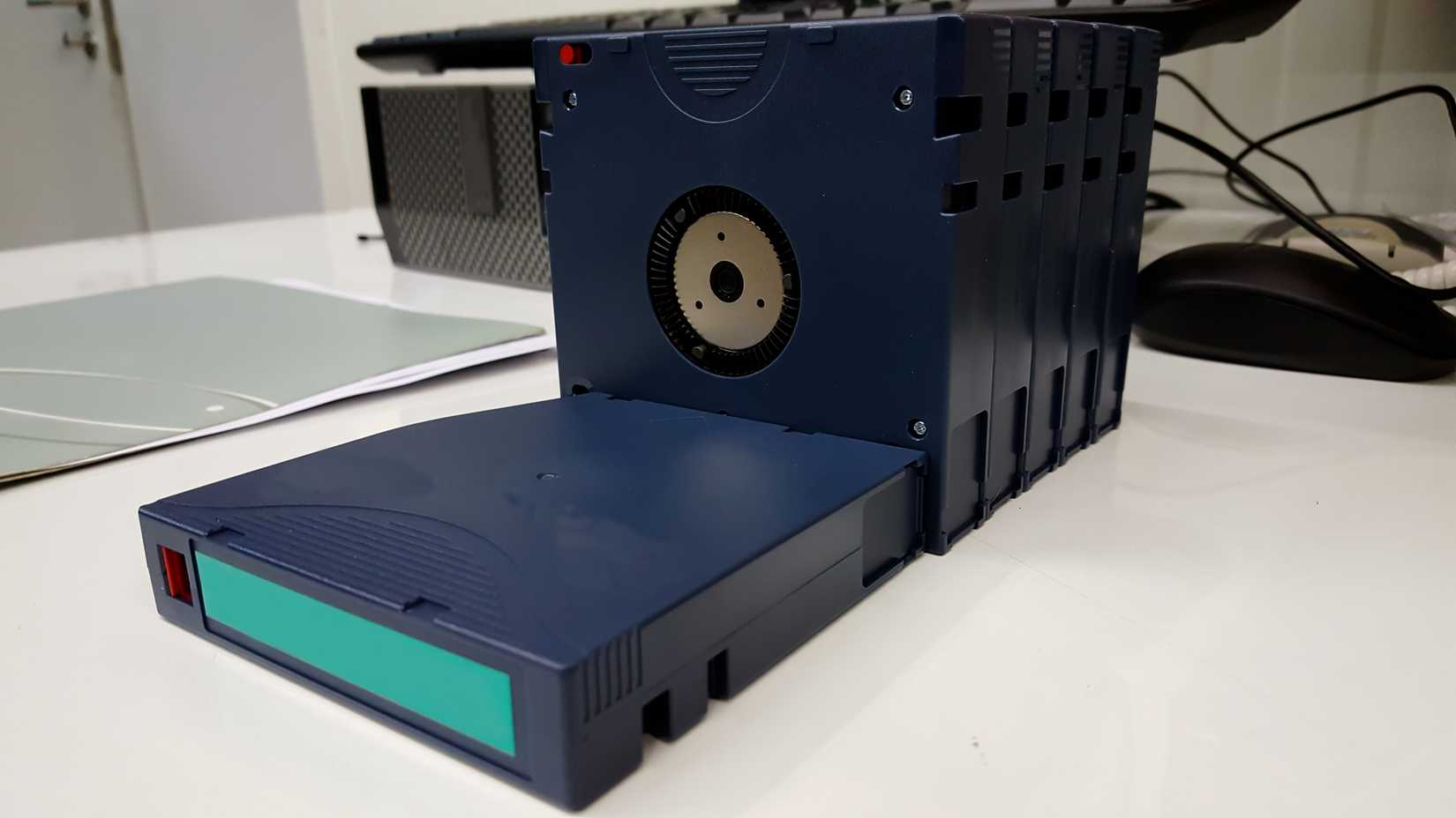 Computer backup tape for data recovery stand like dominoes.