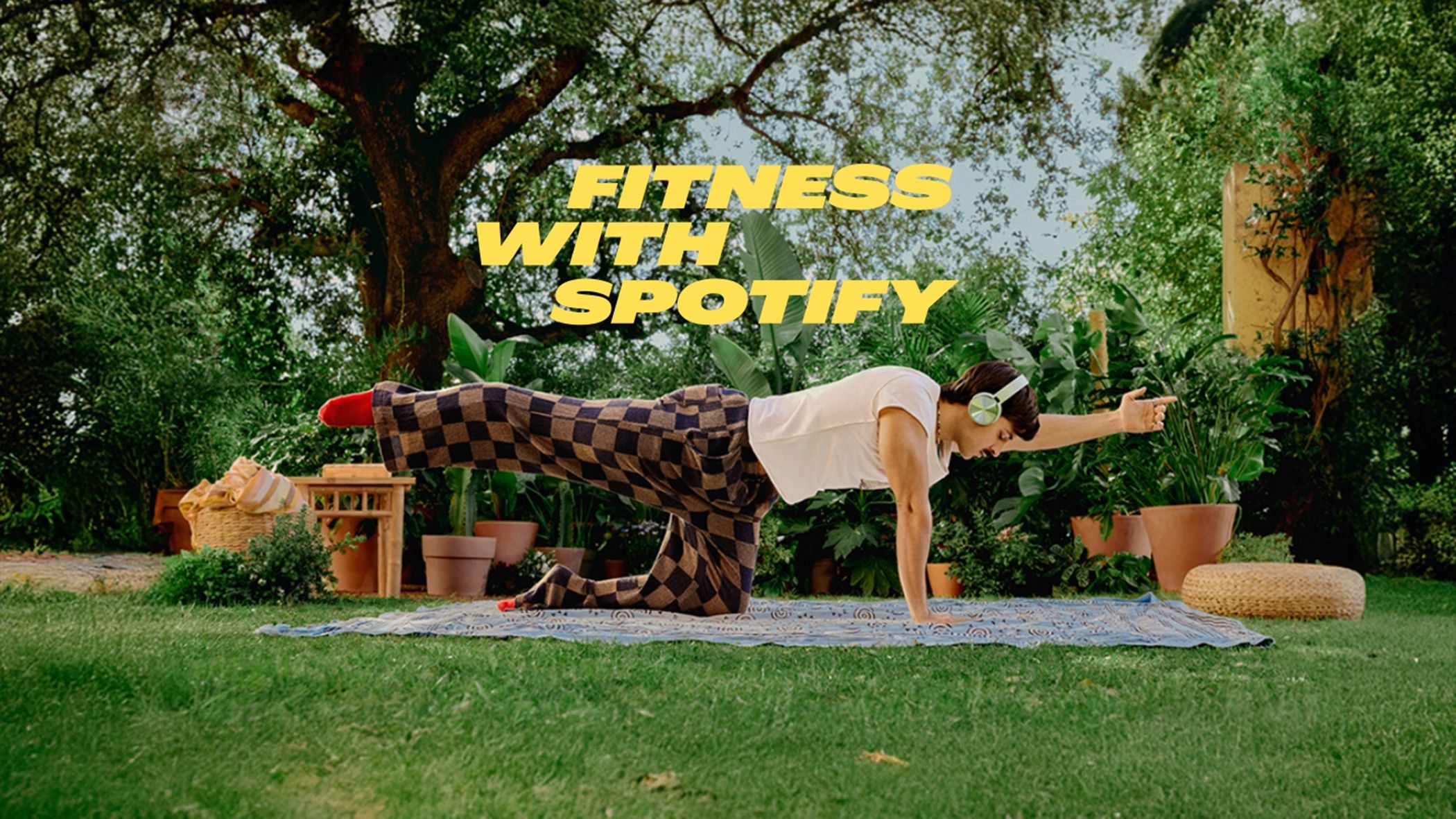 Fitness with Spotify as a person conducts workouts wearing headphones