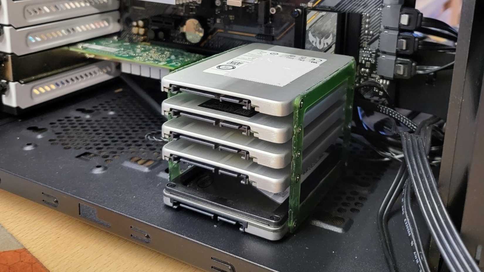Stacked SSDs with a 3D printed bracket in a PC case.