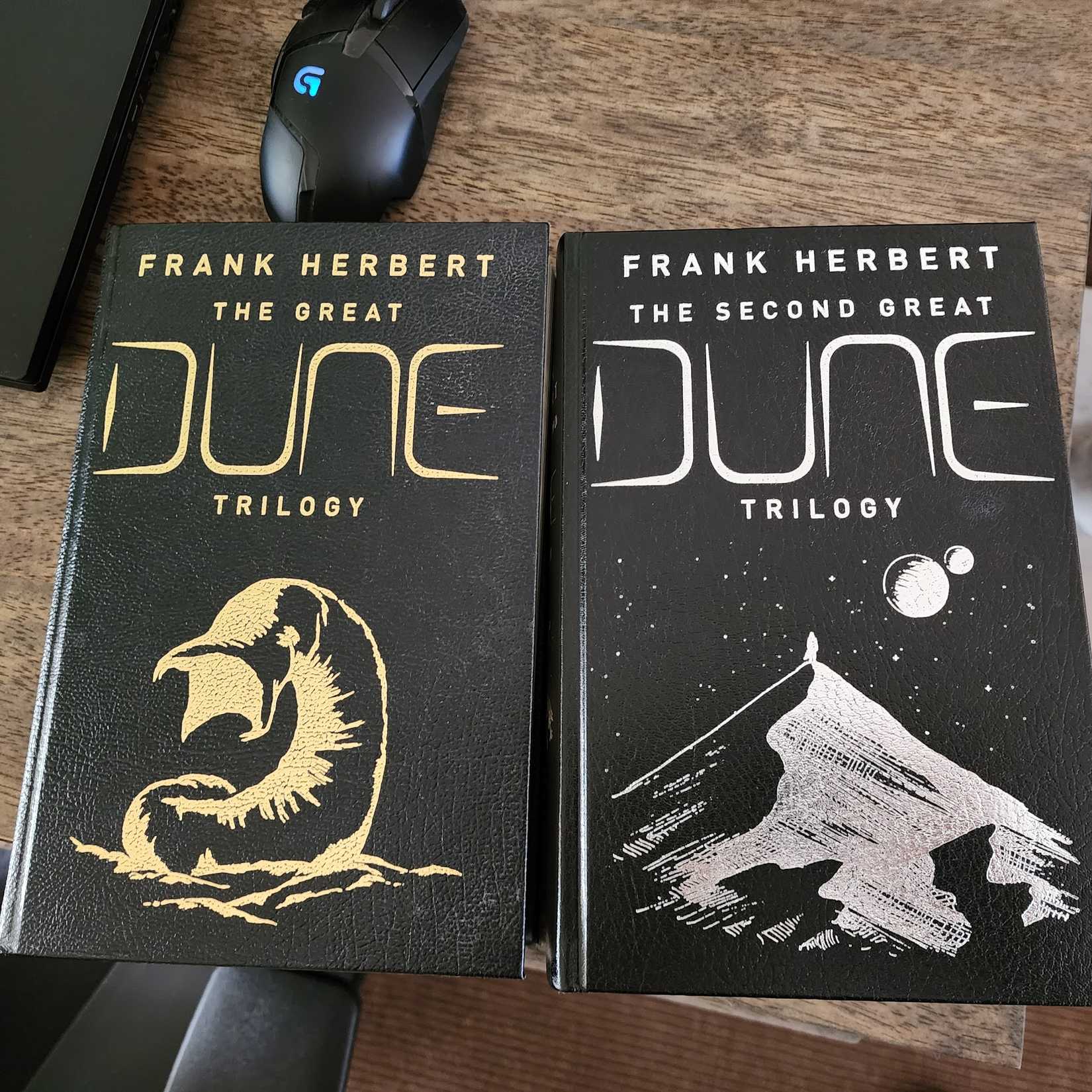 On a table are two leather-bound Dune books.