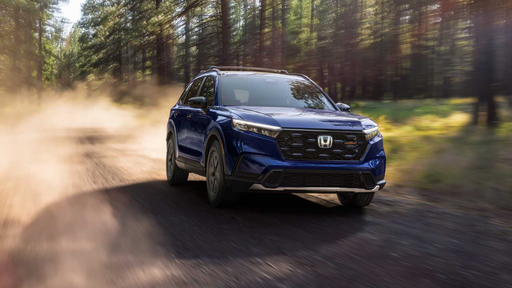Dynamic front 3/4 shot of a blue 2025–2026 Honda- CR-V TrailSport Hybrid.