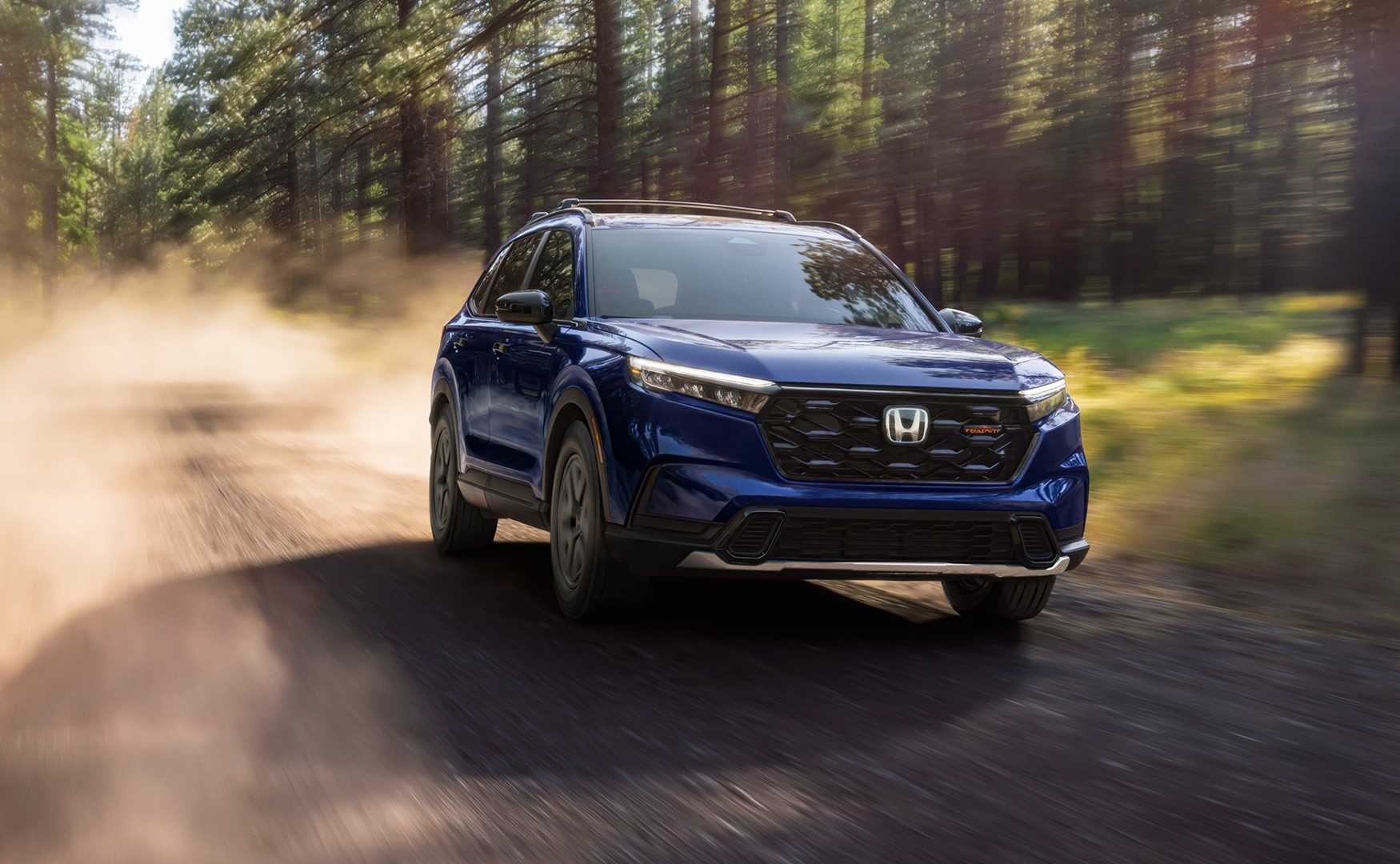 Dynamic front 3/4 shot of a blue 2025–2026 Honda- CR-V TrailSport Hybrid.