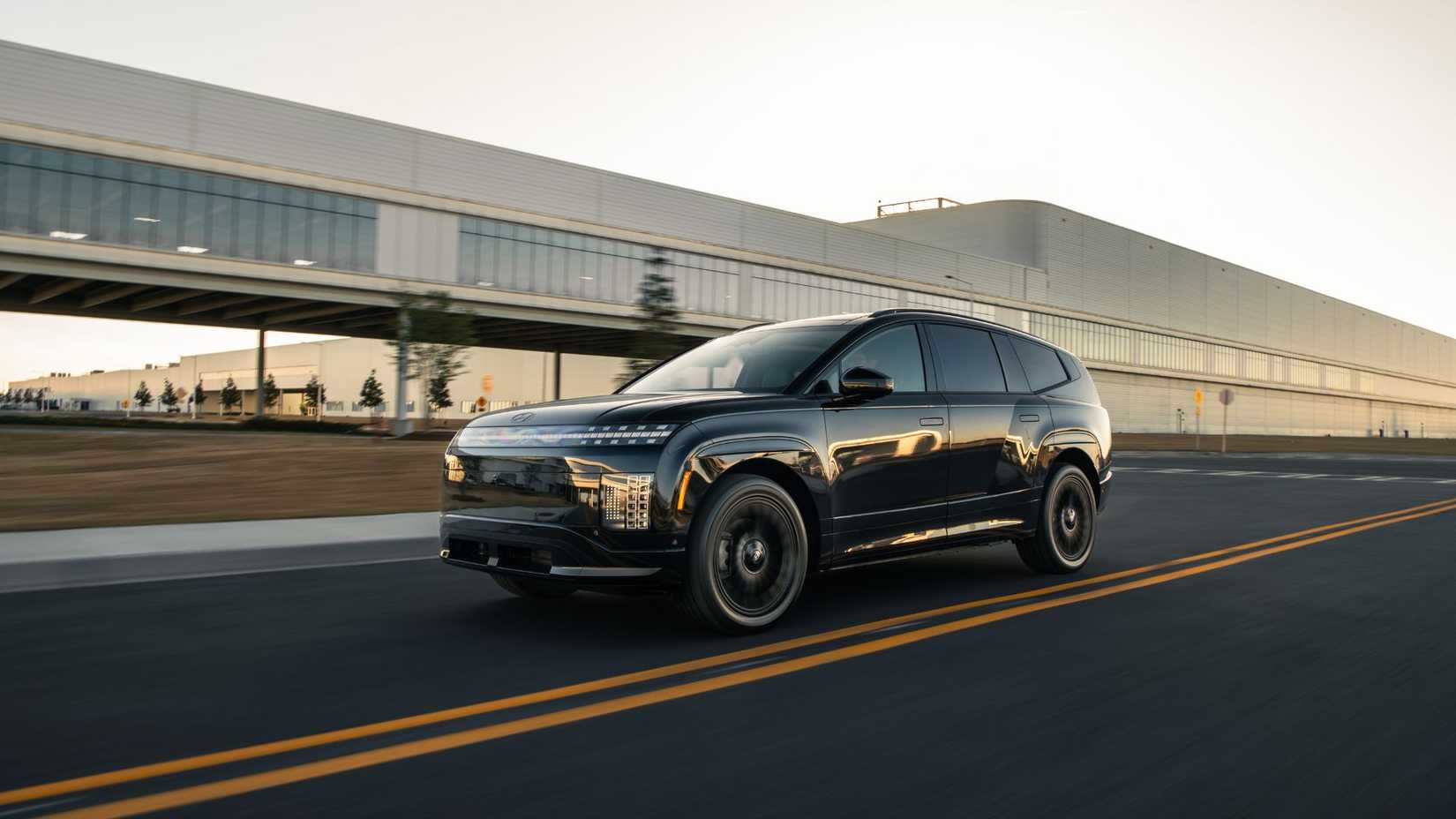Dynamic front 3/4 shot of a 2027 Hyundai Ioniq 9 Calligraphy Black Ink.