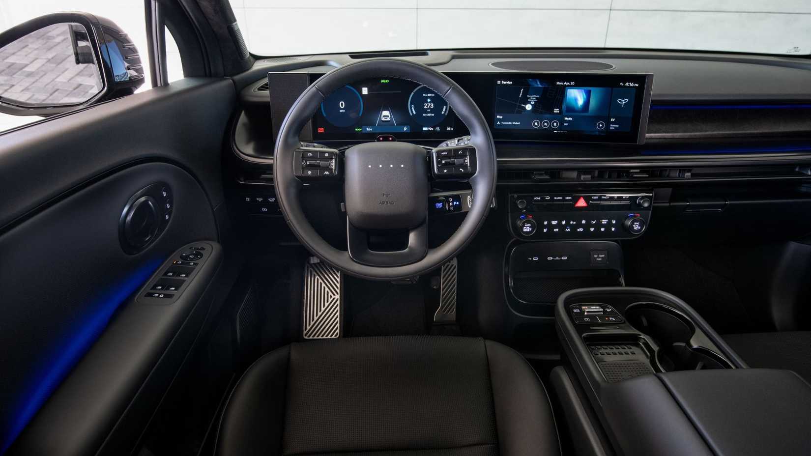 Close-up shot of the steering wheel and dashboard inside the cabin of a 2027 Hyundai Ioniq 9 Calligraphy Black Ink.
