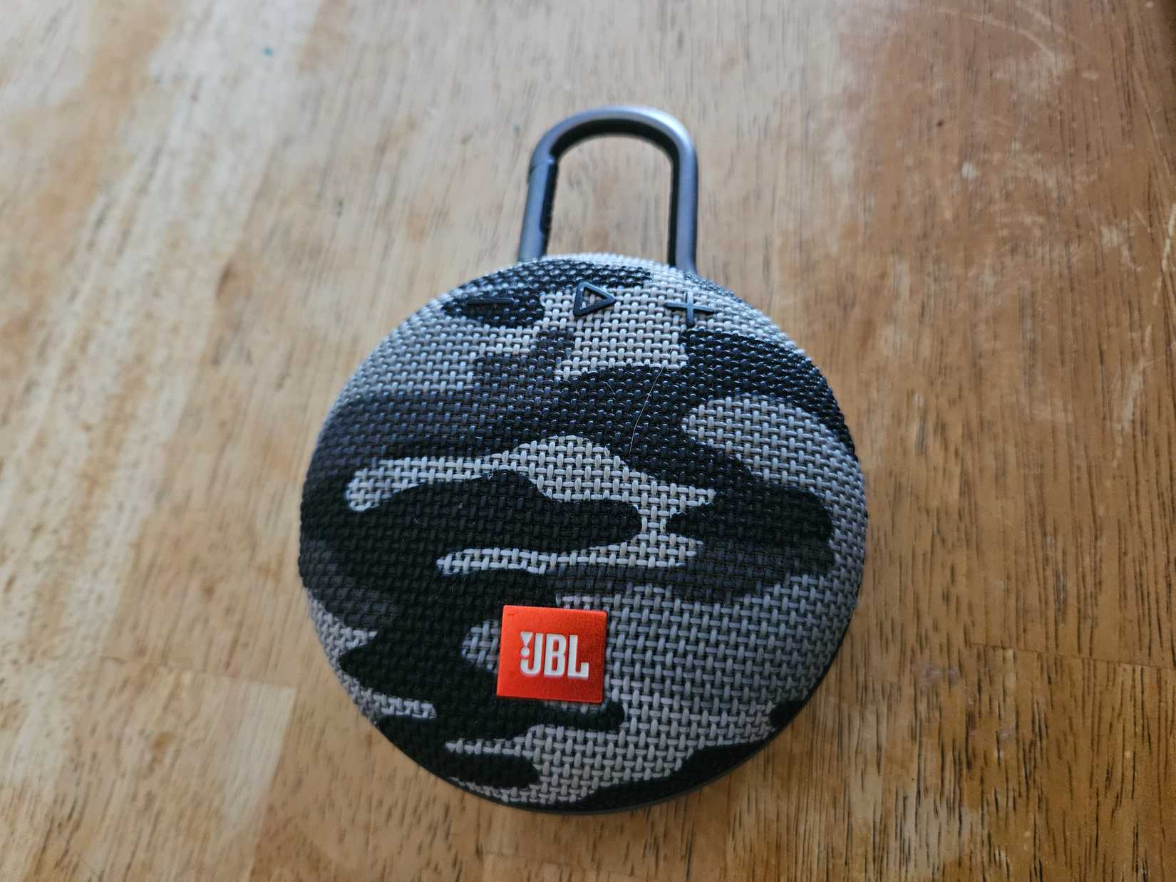 A JBL Bluetooth speaker on a table