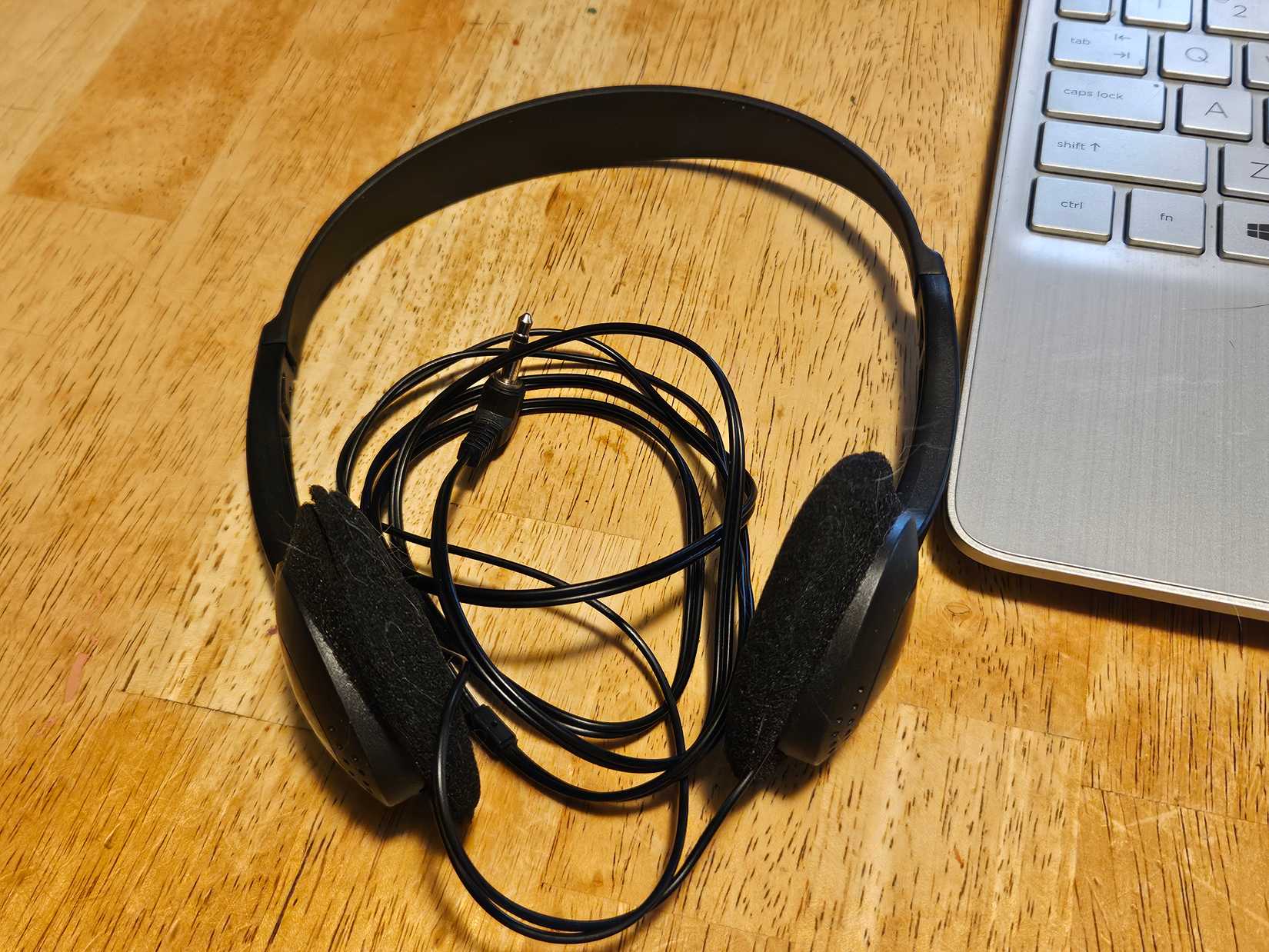 A pair of black Sony headphones on a table.